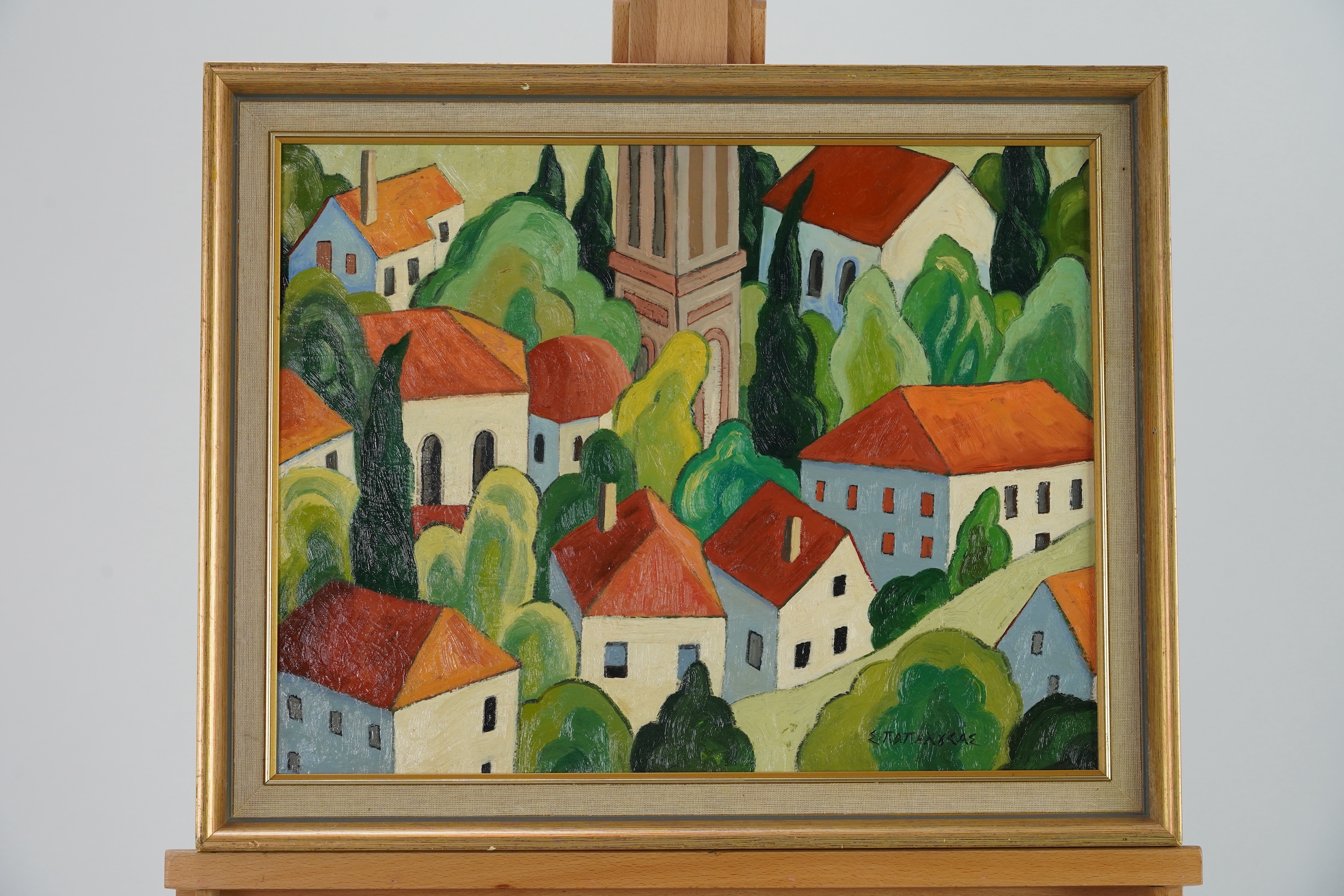 Attributed to Spyros Papaloukas, Greek 1892-1957, Townscape with red roofed buildings and trees around a tower